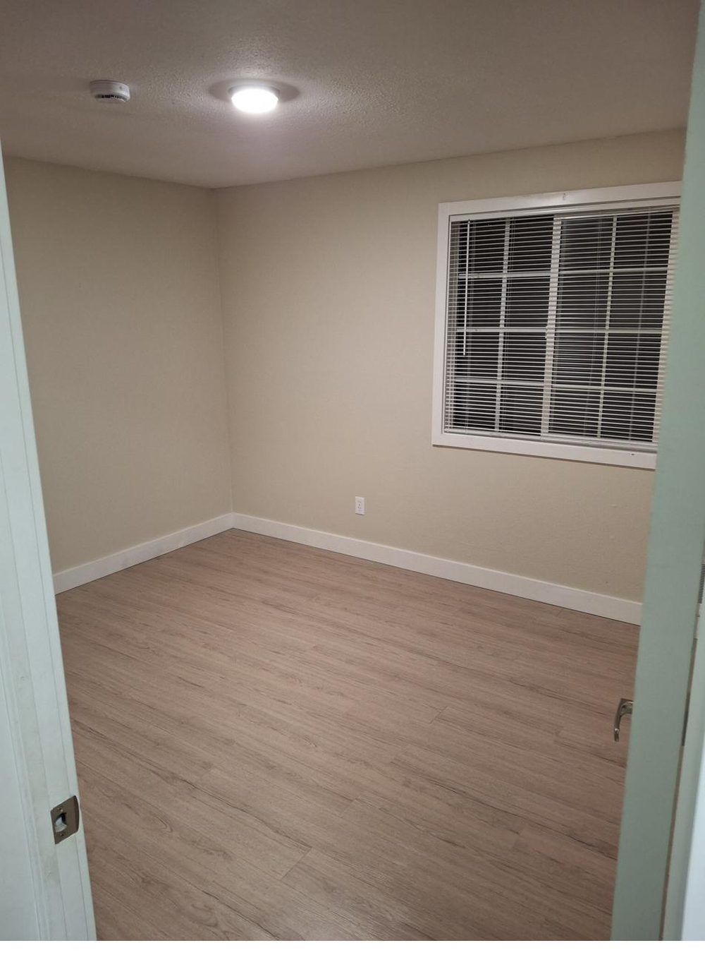 Room with newly installed wood-look flooring