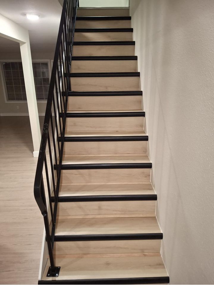 Staircase with refinished wood treads and black metal railing