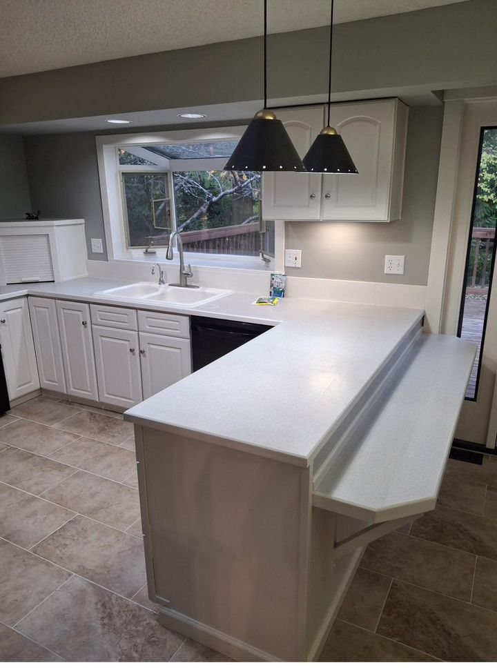 Elegant kitchen with peninsula counter and window over the sink